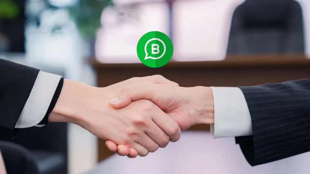 9 - Gambar dua tangan yang saling menjabat dengan icon whatsapp bisnis di atas kedua tangan tersebut