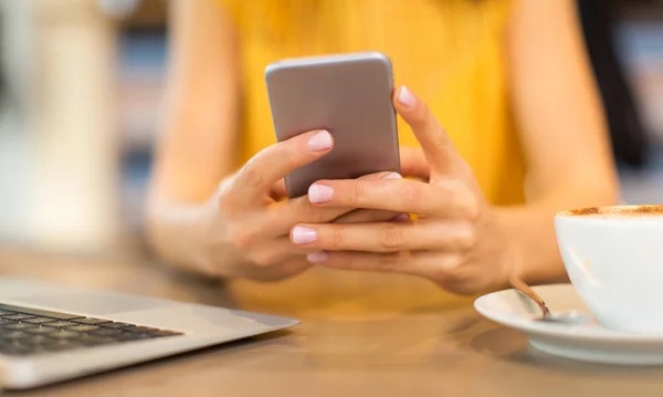 Seseorang sedang mengirim SMS melalui HP